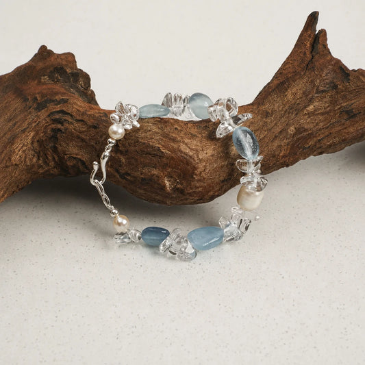 Close-up of freshwater pearl, white quartz and aquamarine bracelet