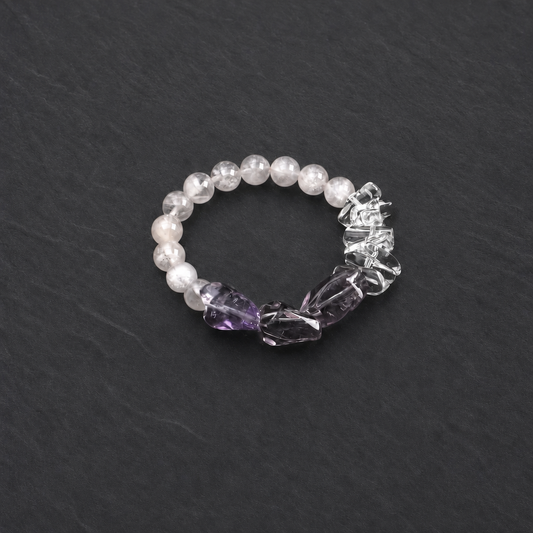 Close-up of amethyst, rose quartz and white crystal spike bracelet