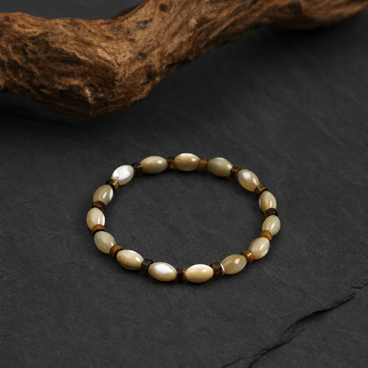 Close-up of tiger eye and shell bead sterling silver bracelet
