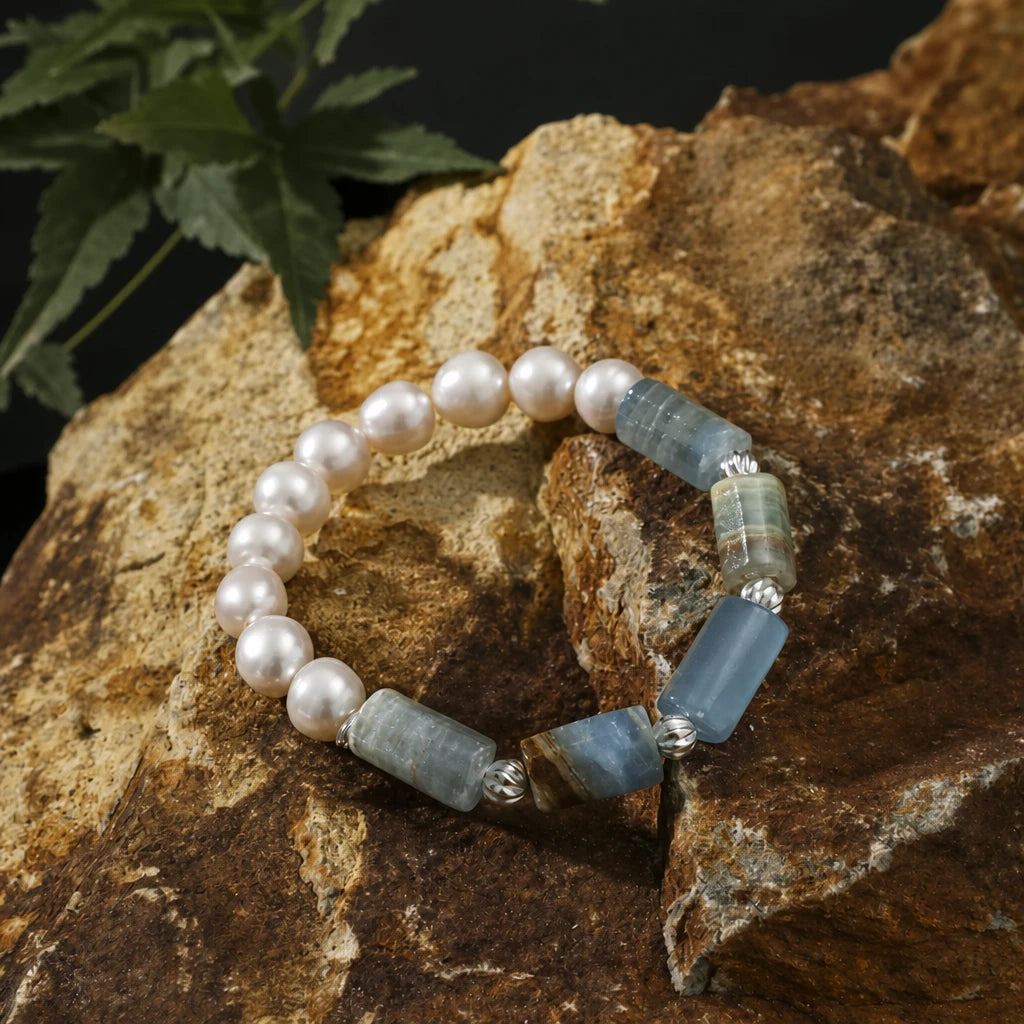 Close-up detail of sea glass stone and pearl bracelet