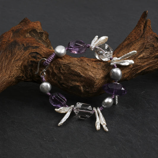 Close-up of white quartz point, amethyst and baroque pearl bracelet