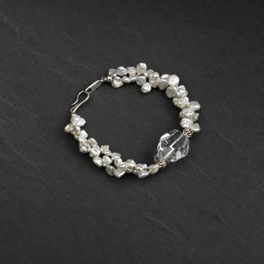 Close-up of white quartz double point and petal baroque pearl bracelet